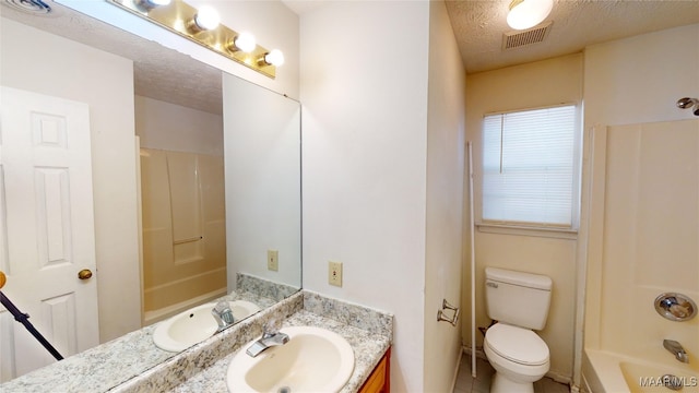 full bathroom featuring vanity, a textured ceiling, toilet, and shower / bathtub combination