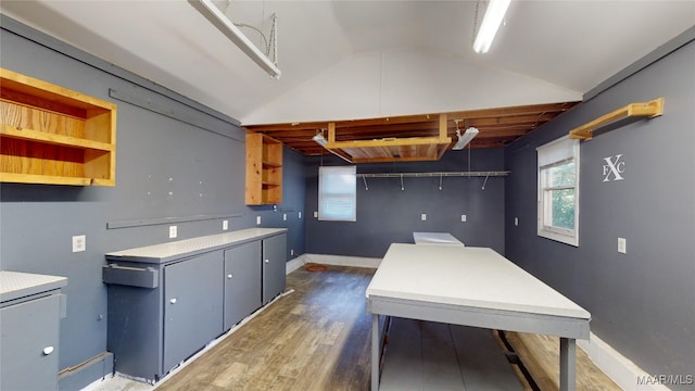 kitchen featuring dark hardwood / wood-style flooring and vaulted ceiling