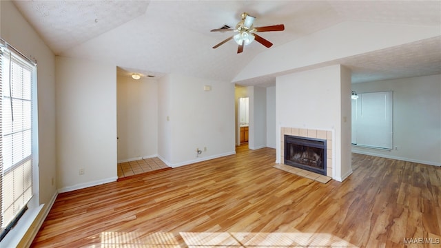 unfurnished living room with hardwood / wood-style floors, a fireplace, a textured ceiling, and ceiling fan