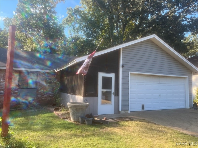 garage featuring a yard and wood walls