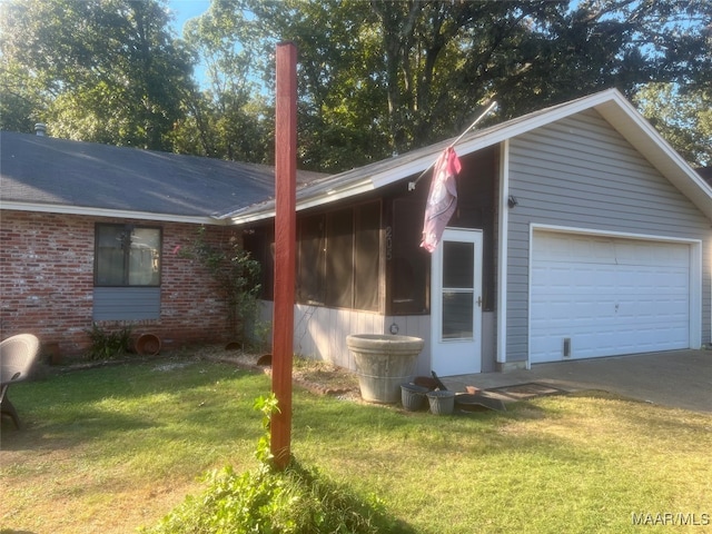 view of home's exterior featuring a lawn and a garage