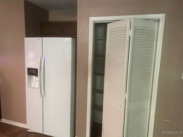 kitchen featuring white fridge with ice dispenser