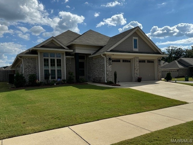 view of front of house with a front yard and a garage