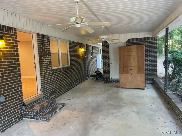 unfurnished sunroom featuring ceiling fan