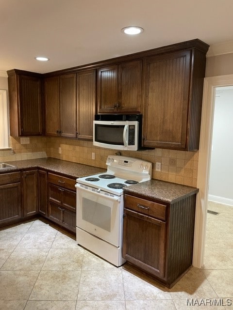 kitchen featuring dark brown cabinets, backsplash, white electric range oven, and crown molding