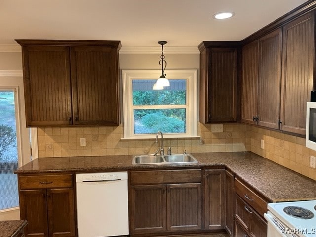 kitchen featuring pendant lighting, white appliances, tasteful backsplash, sink, and ornamental molding