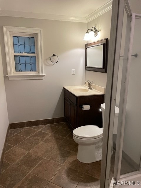 bathroom with ornamental molding, vanity, toilet, and tile patterned floors