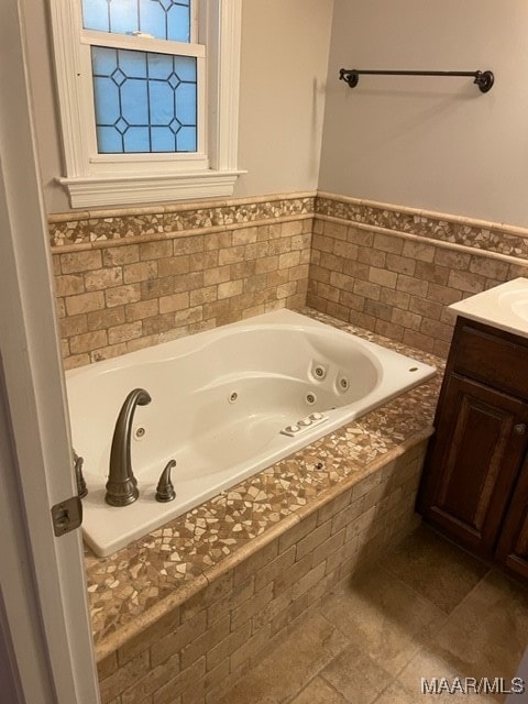 bathroom featuring tiled bath, tile patterned floors, and vanity