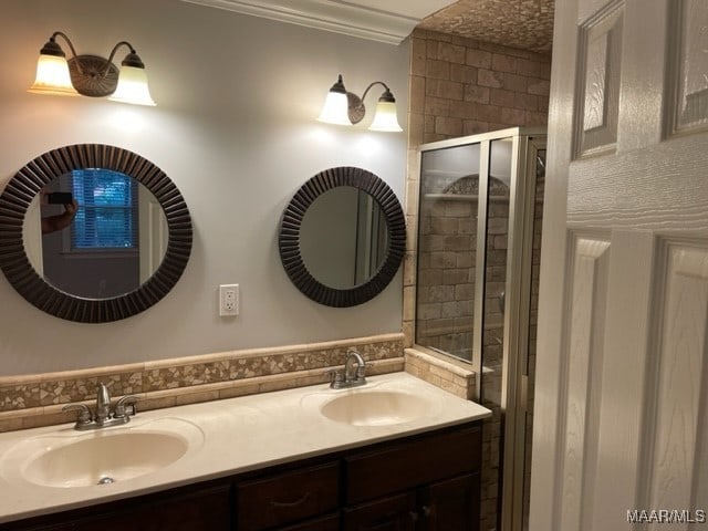 bathroom with crown molding, a shower with door, and vanity