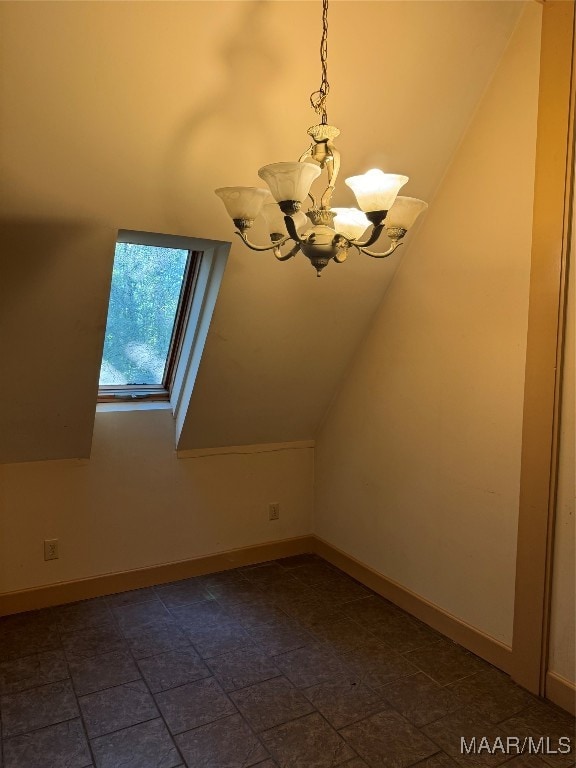 additional living space with lofted ceiling and a chandelier