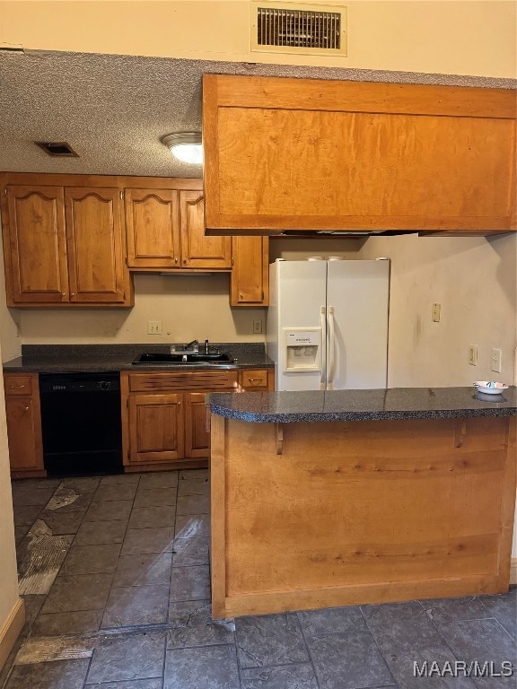 kitchen featuring dishwasher, white fridge with ice dispenser, sink, and a textured ceiling