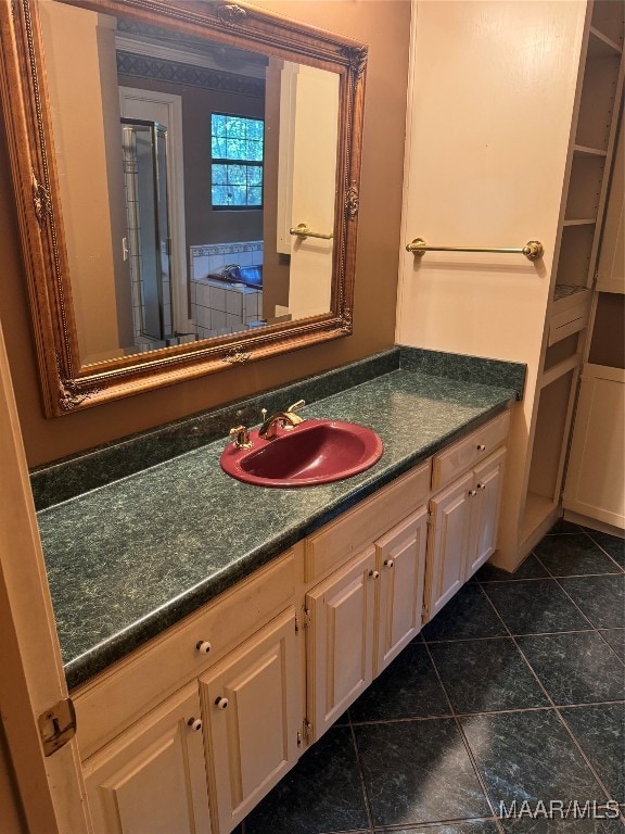 bathroom with tile patterned floors and vanity