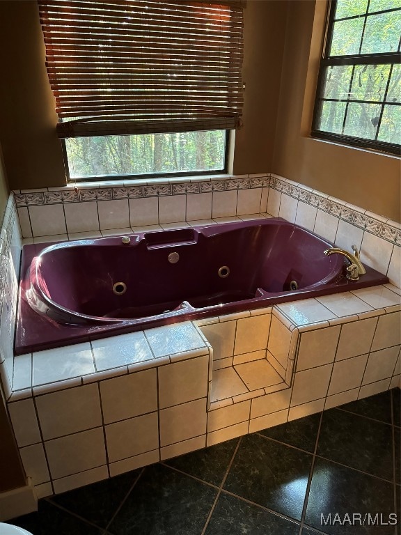 bathroom with tiled bath and tile patterned flooring