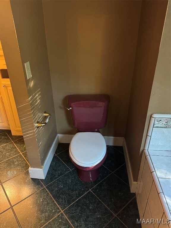 bathroom with tile patterned flooring and toilet