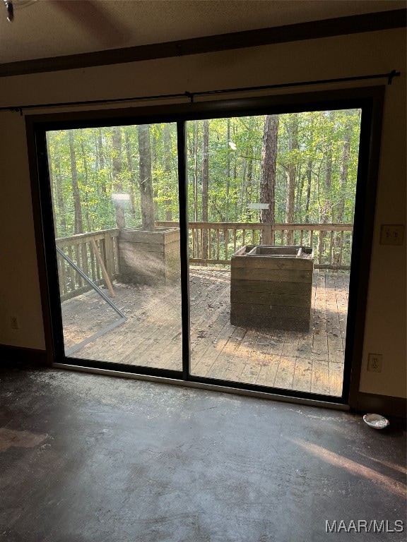 doorway to outside with concrete floors