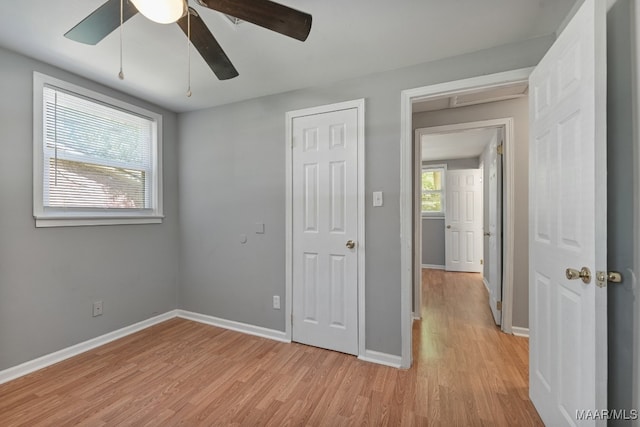 unfurnished bedroom with ceiling fan and light hardwood / wood-style flooring