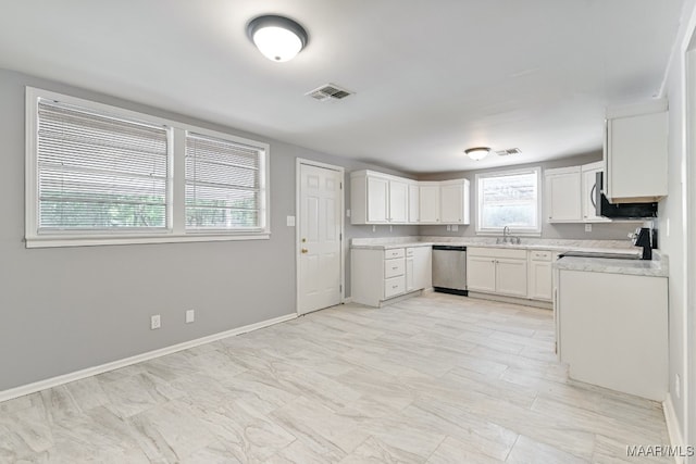 kitchen featuring black range oven, stainless steel dishwasher, sink, and white cabinets