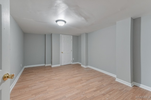 basement with light hardwood / wood-style floors