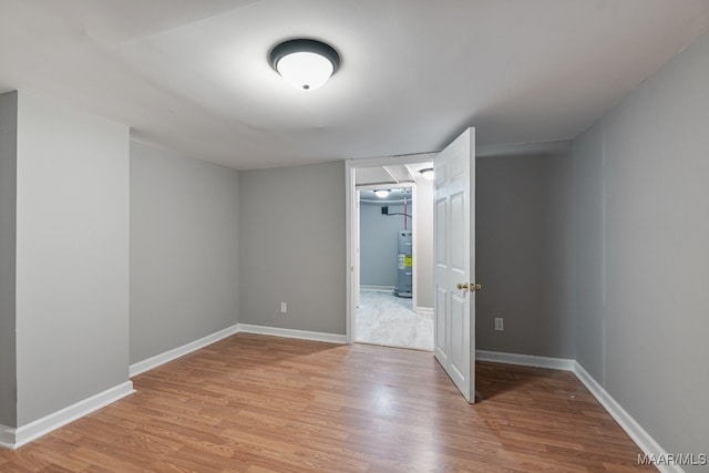 spare room with light hardwood / wood-style floors and electric water heater