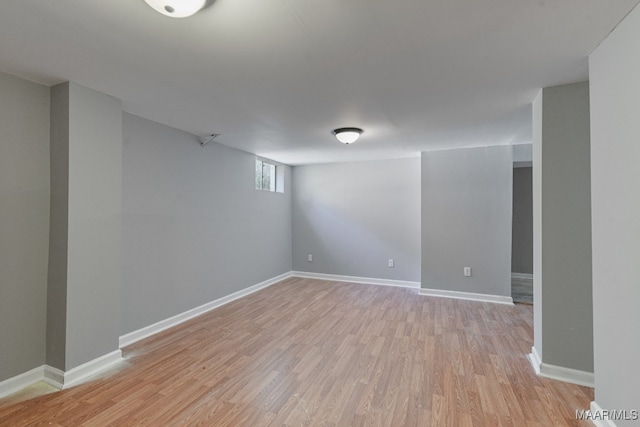 basement with light hardwood / wood-style flooring