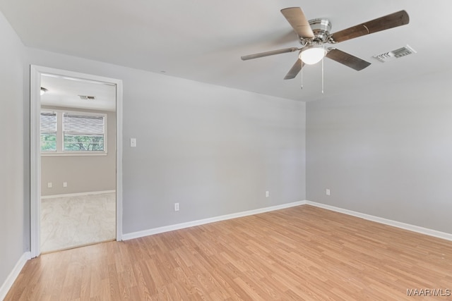 spare room featuring ceiling fan and light hardwood / wood-style floors