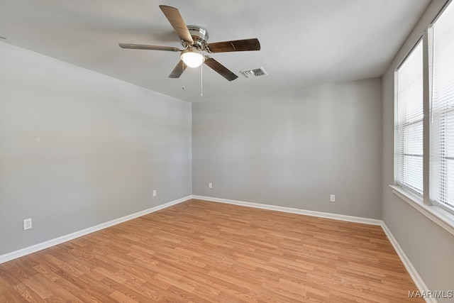 unfurnished room featuring light wood-type flooring and ceiling fan