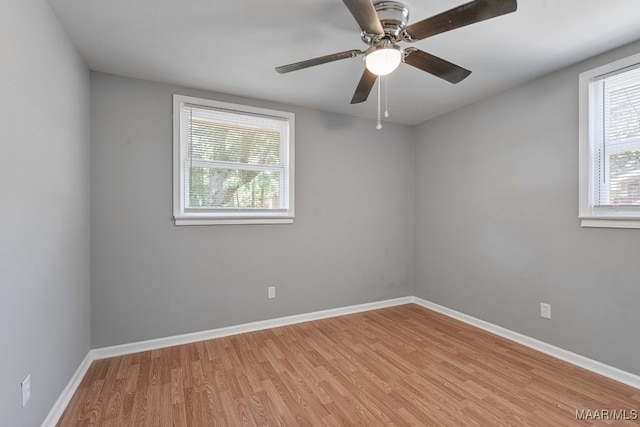 spare room with light wood-type flooring and ceiling fan