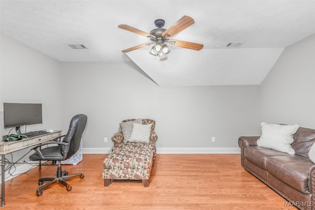 office with lofted ceiling, light hardwood / wood-style floors, a textured ceiling, and ceiling fan