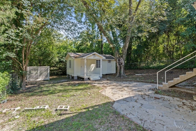 view of yard with an outbuilding and a patio area