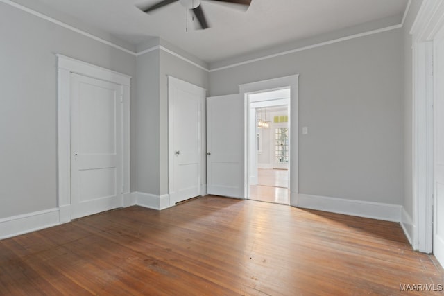 unfurnished bedroom with ornamental molding, ceiling fan, and hardwood / wood-style floors