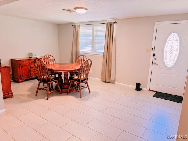 dining room featuring a textured ceiling