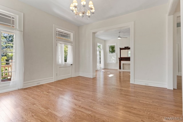 entrance foyer featuring ceiling fan with notable chandelier and light wood-type flooring