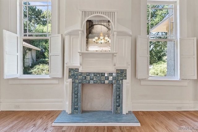 interior details with hardwood / wood-style floors and a chandelier