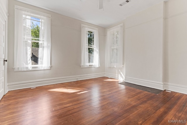 empty room with ceiling fan and wood-type flooring