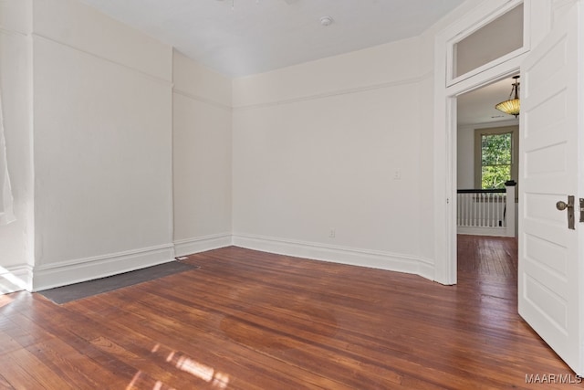 unfurnished room featuring dark wood-type flooring