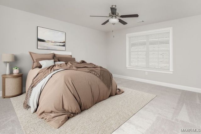 bedroom featuring light carpet and ceiling fan