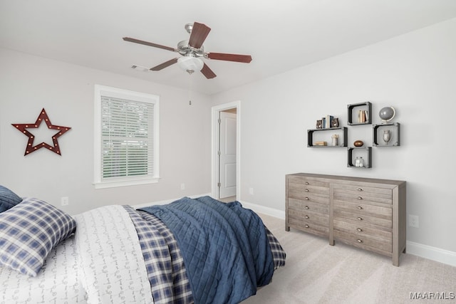 bedroom featuring light colored carpet and ceiling fan