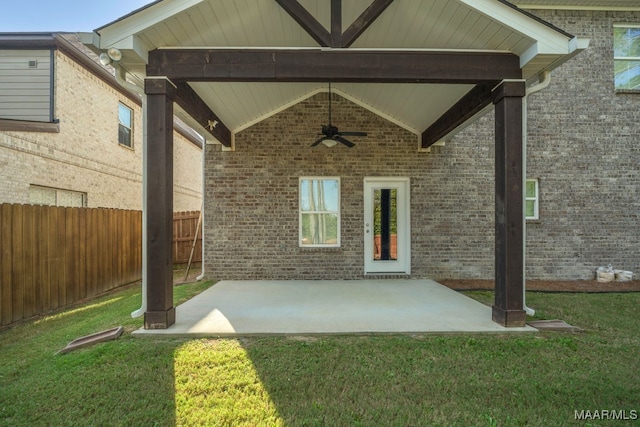 exterior space with ceiling fan, a lawn, and a patio area