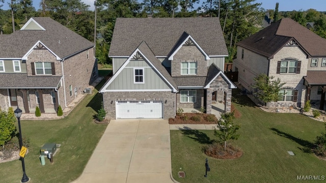 craftsman house with a garage and a front lawn