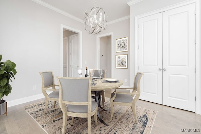 dining room featuring hardwood / wood-style flooring, crown molding, and a chandelier