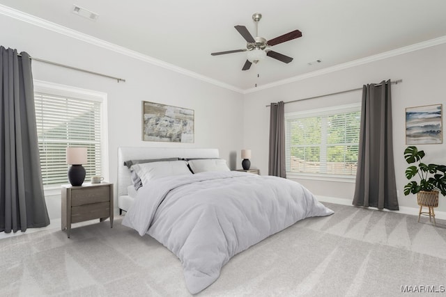 carpeted bedroom with crown molding and ceiling fan