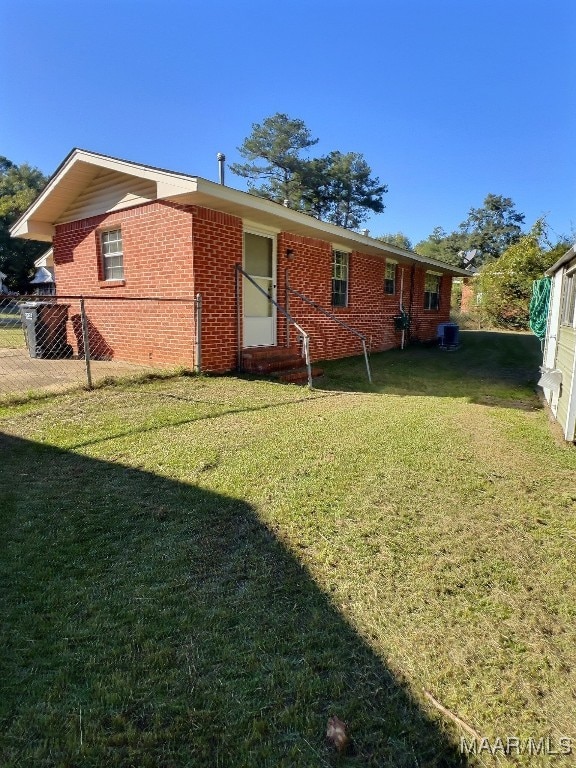 rear view of property featuring a lawn