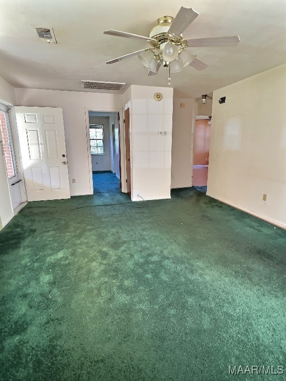 carpeted spare room featuring ceiling fan