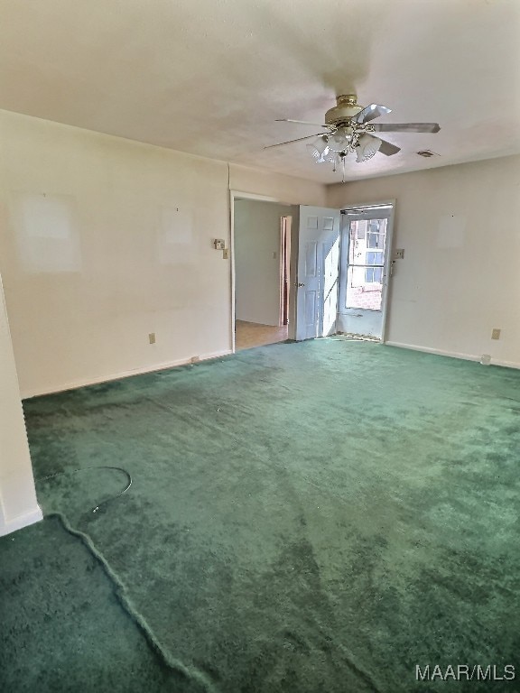 carpeted spare room featuring ceiling fan