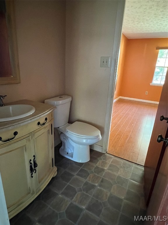 bathroom featuring hardwood / wood-style flooring, vanity, and toilet