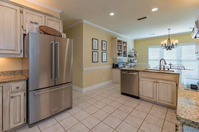 kitchen with light stone countertops, ornamental molding, appliances with stainless steel finishes, and sink