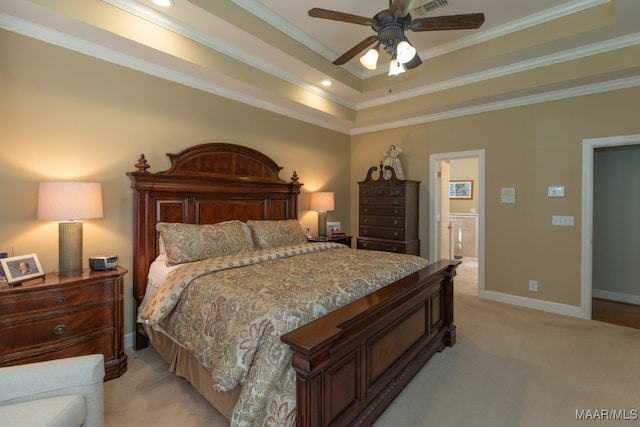 carpeted bedroom with ceiling fan, crown molding, ensuite bath, and a raised ceiling