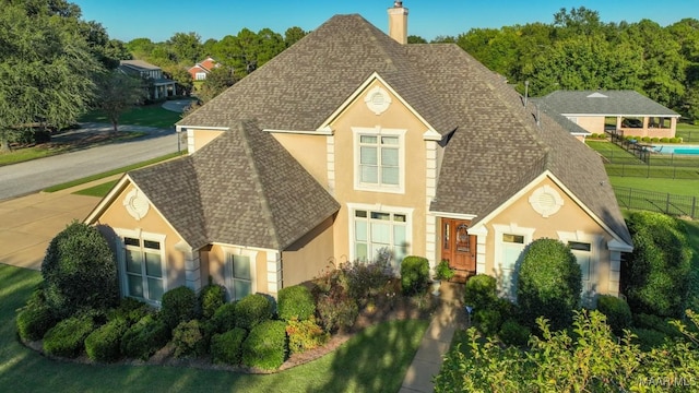 8301 Wynlakes Blvd, Montgomery, AL 36117 - view of front of property featuring a chimney, fence, a shingled roof, and stucco siding