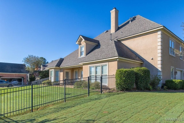 8301 Wynlakes Blvd, Montgomery, AL 36117 - back of property with a yard, roof with shingles, stucco siding, and fence