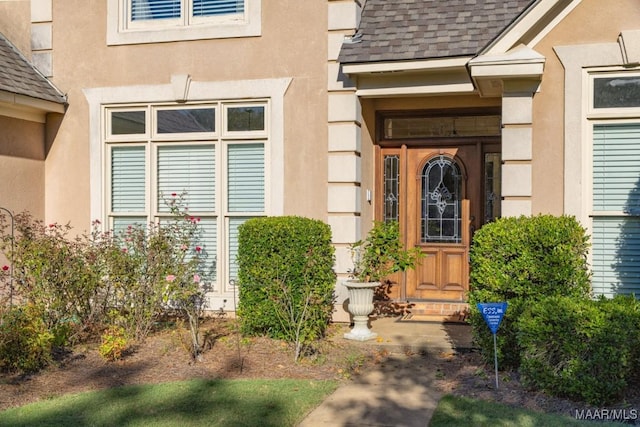 8301 Wynlakes Blvd, Montgomery, AL 36117 - view of exterior entry featuring a shingled roof and stucco siding